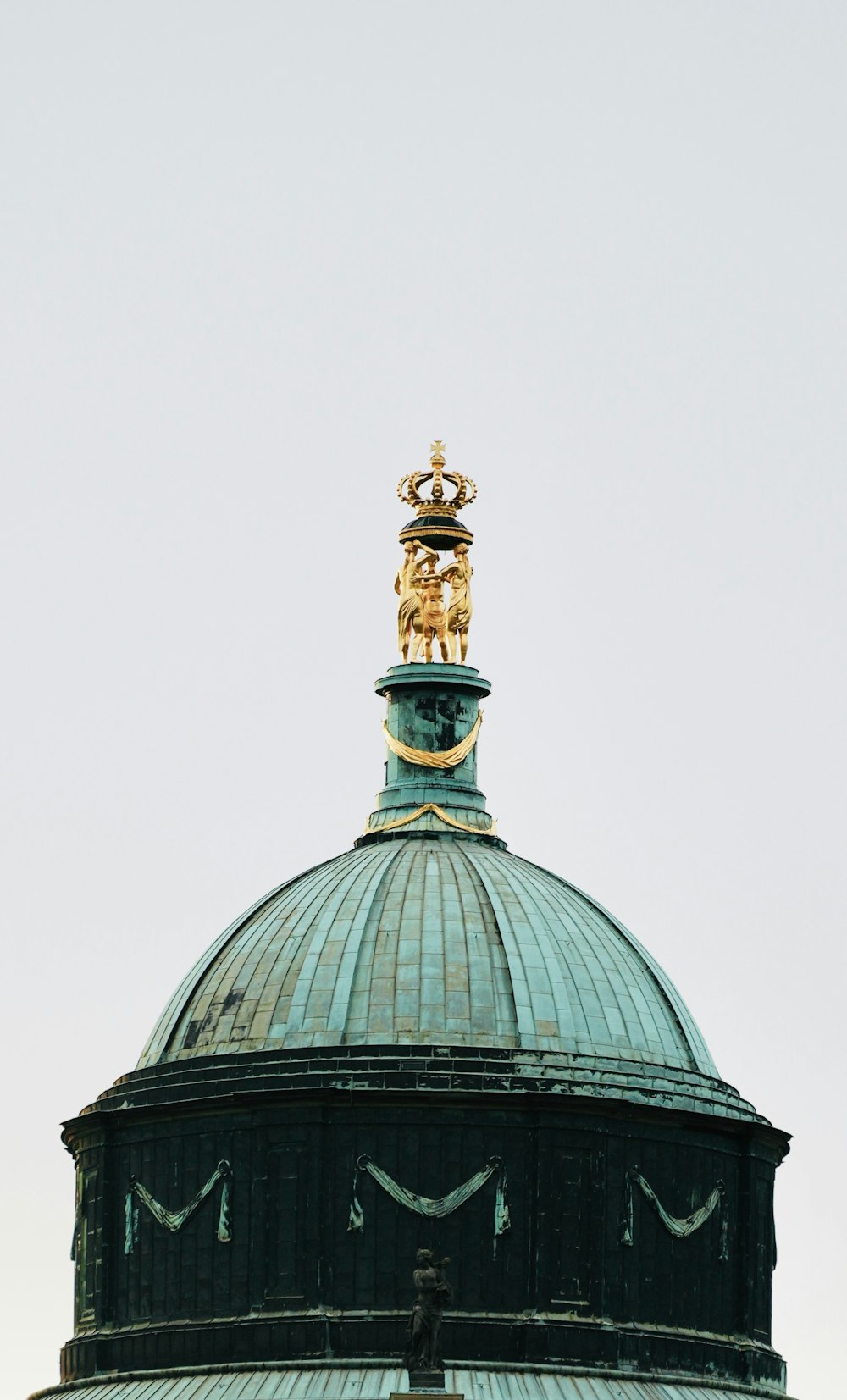 the top of a building with a statue on top of it