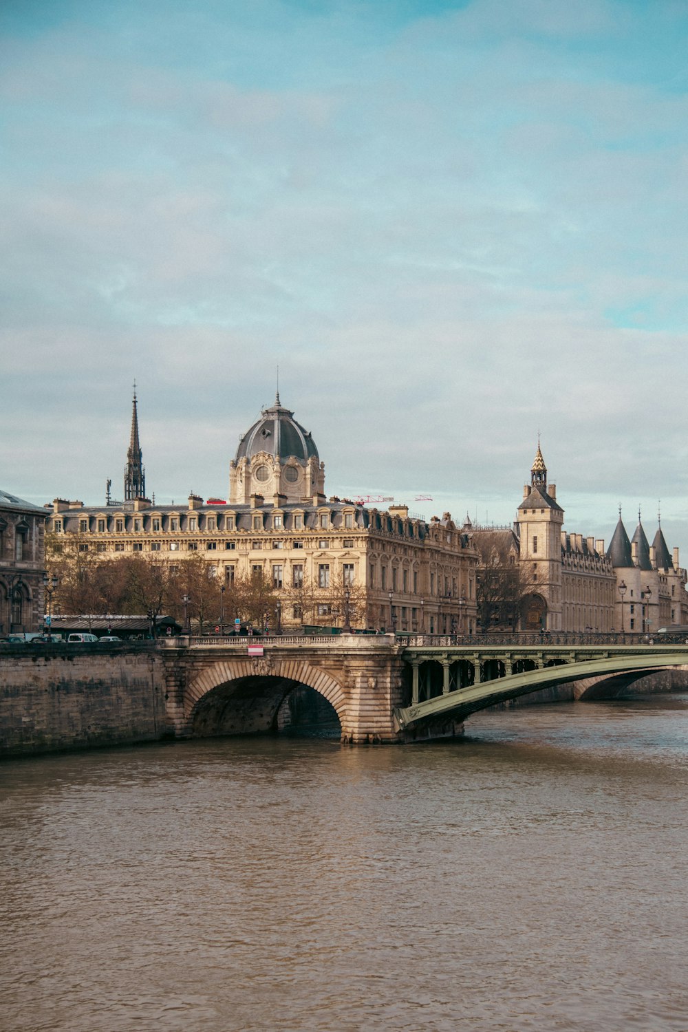 a bridge over a body of water with a building in the background