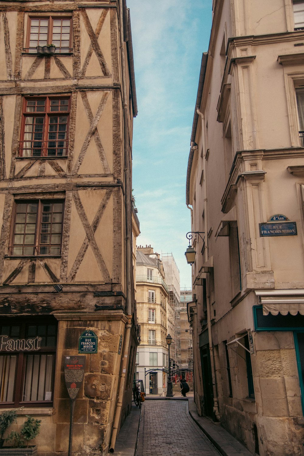 a narrow city street with buildings on both sides