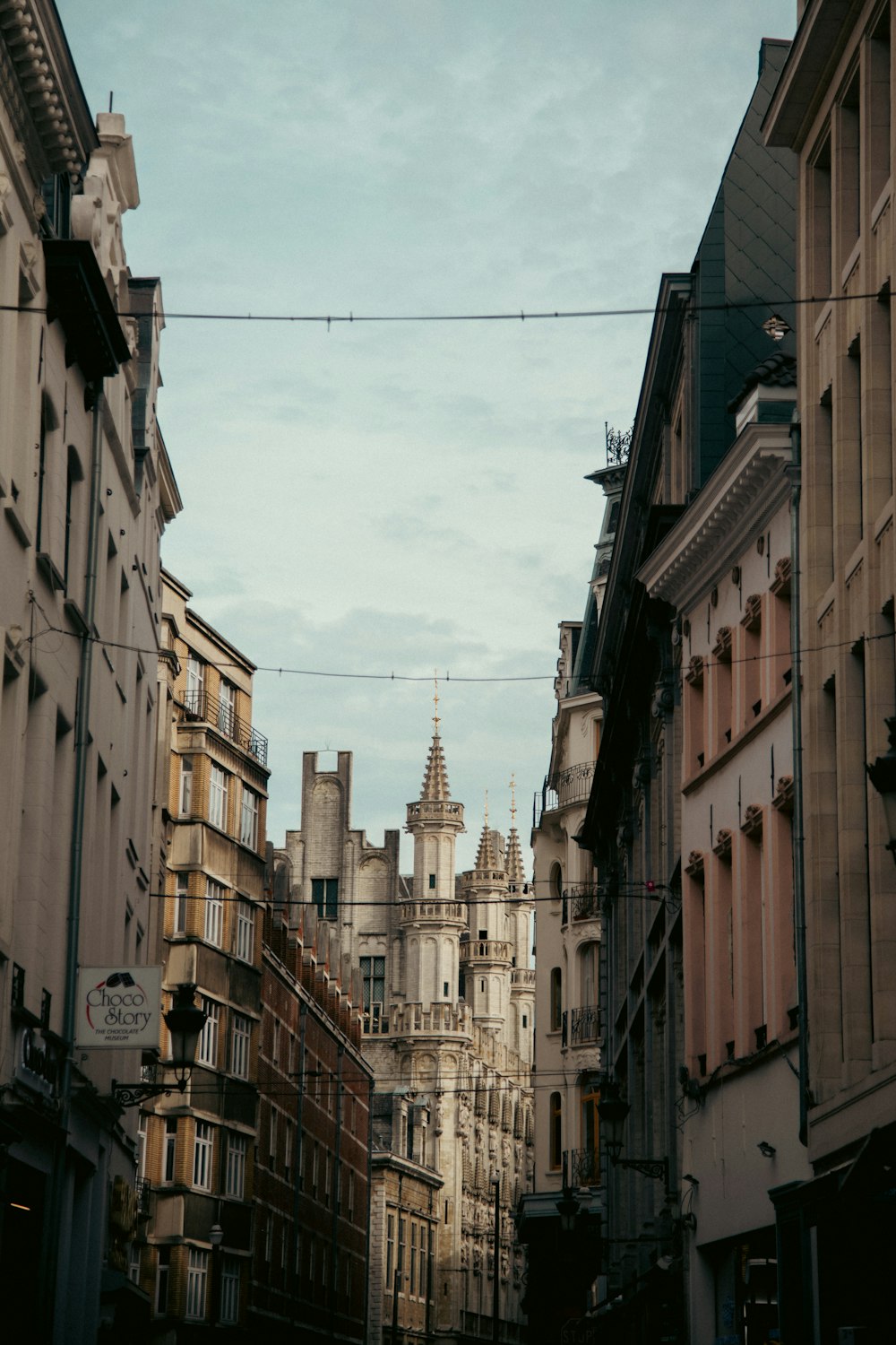 a narrow city street lined with tall buildings