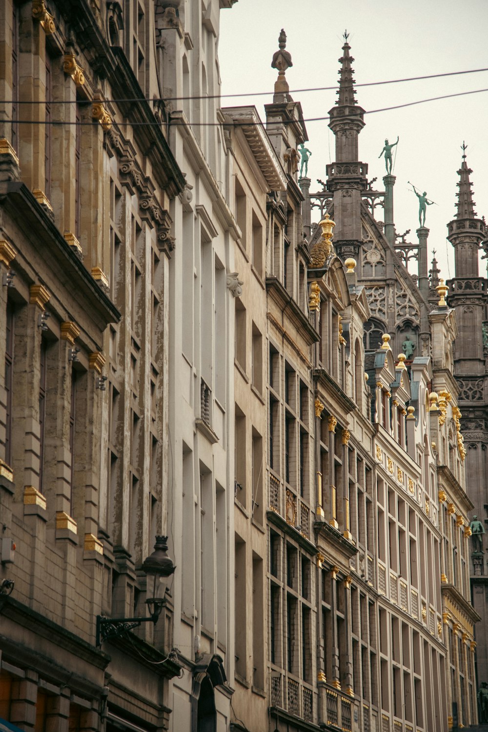 a row of buildings with clocks on each of them