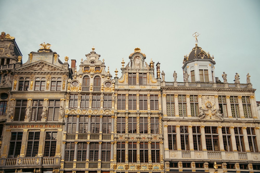 a large building with many windows and statues on it