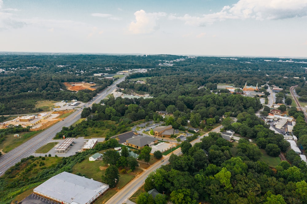 an aerial view of a small town surrounded by trees