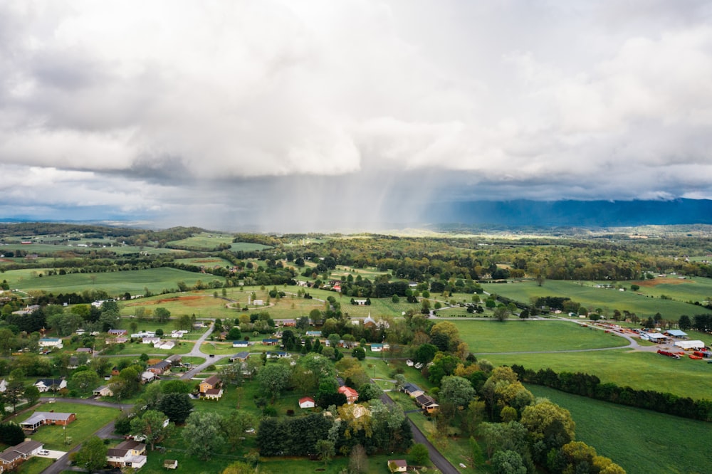 an aerial view of a small town surrounded by green fields