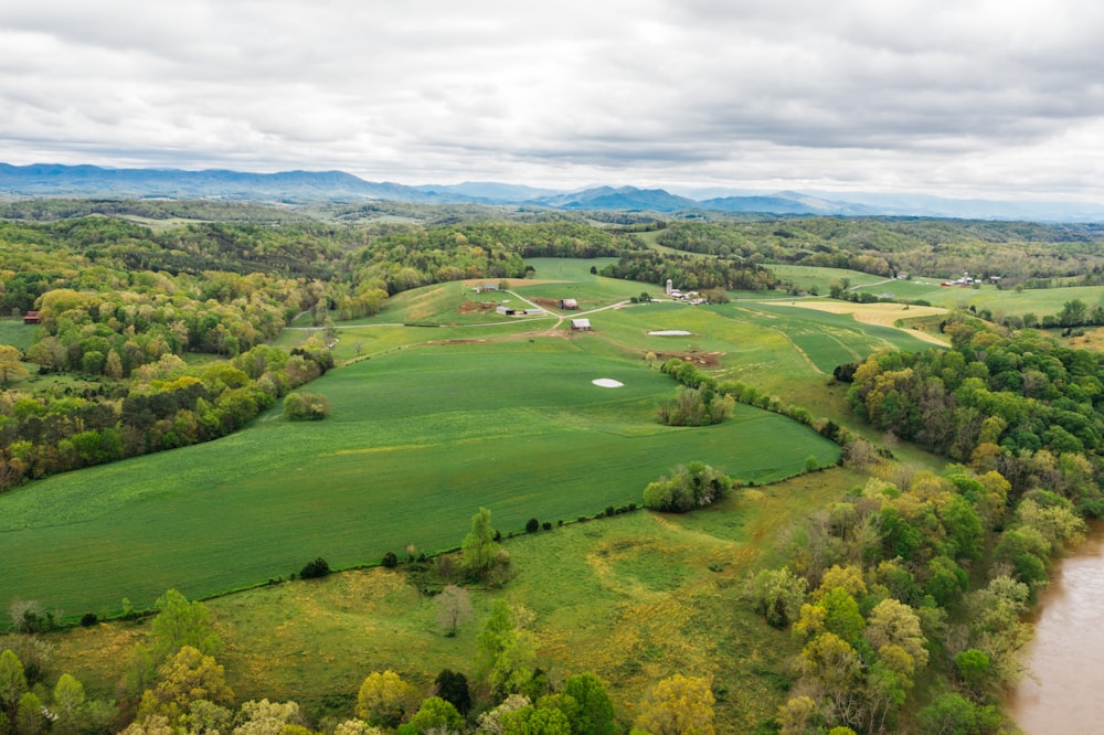 an aerial view of a large green field