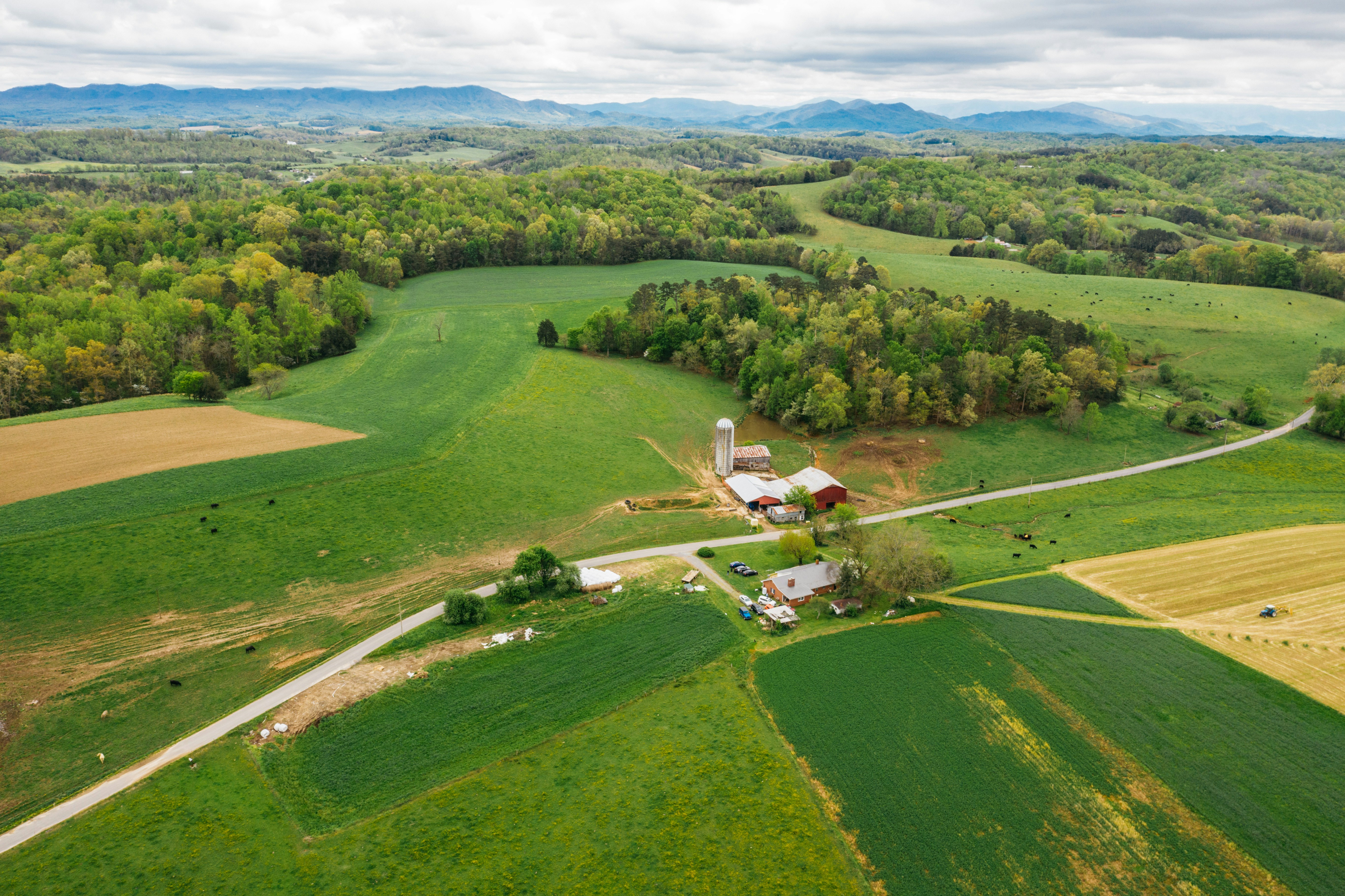 an aerial view of a farm in the country, 