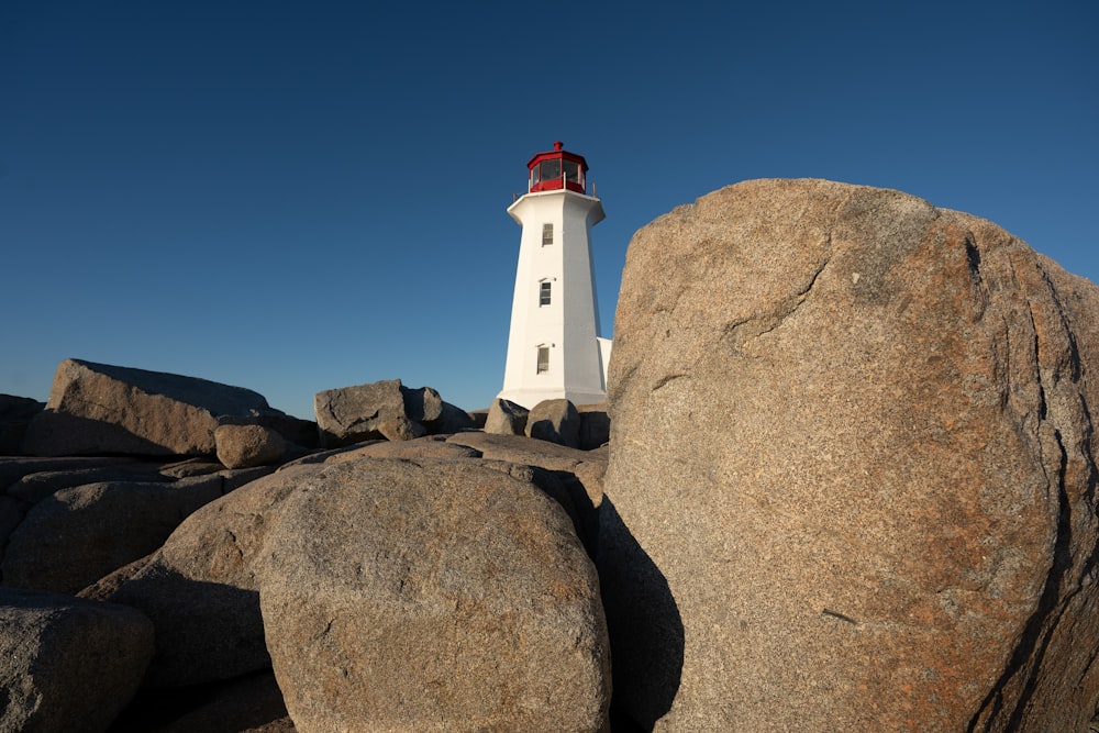 a light house sitting on top of a large rock