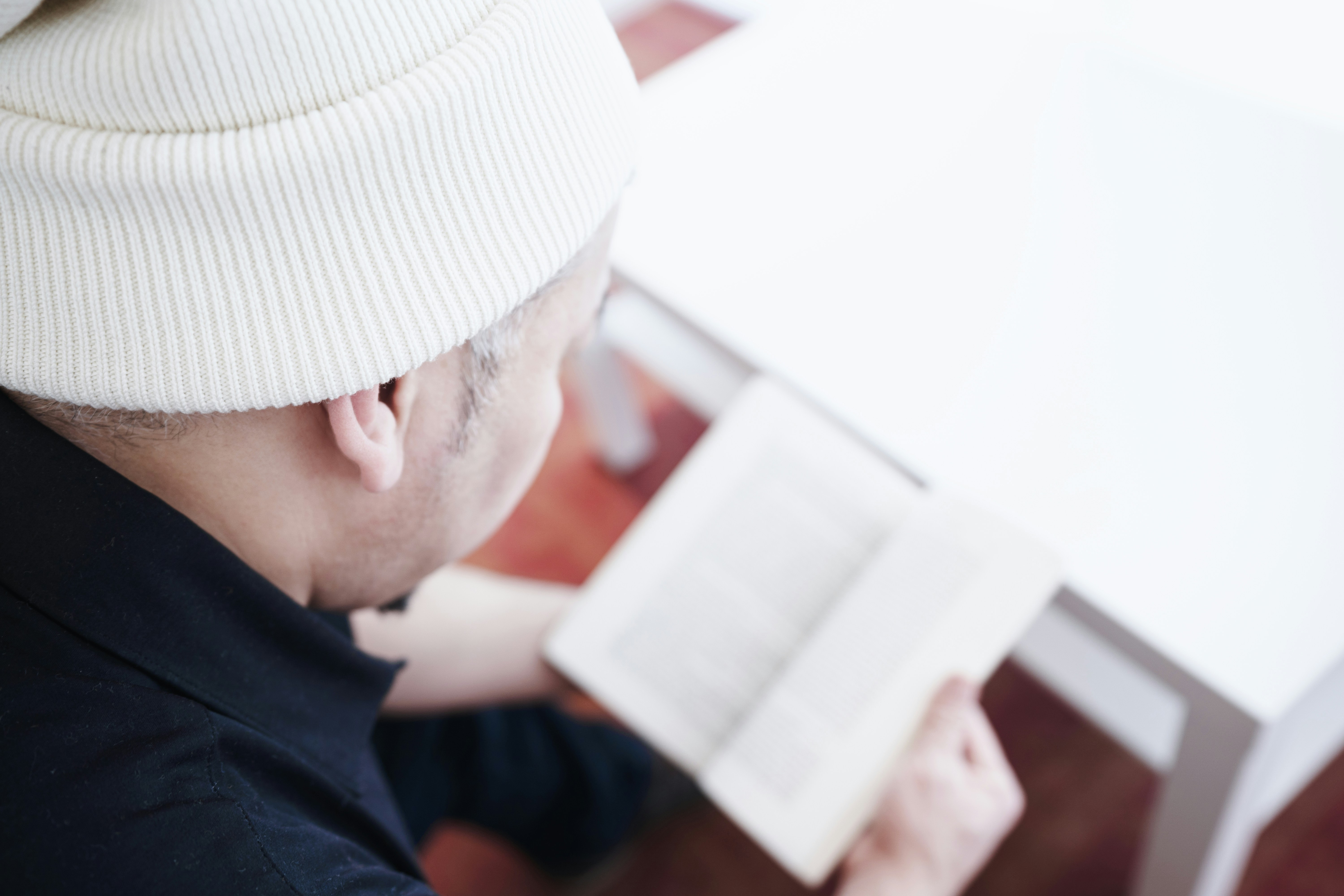 a man sitting at a table reading a book