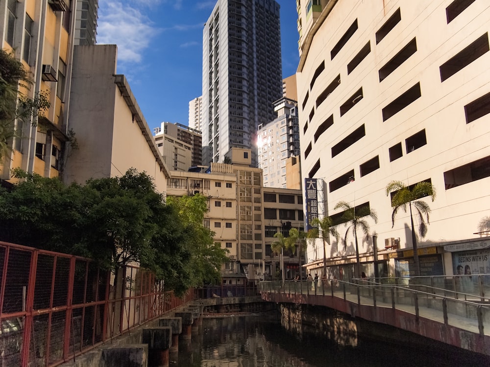 a river running through a city next to tall buildings