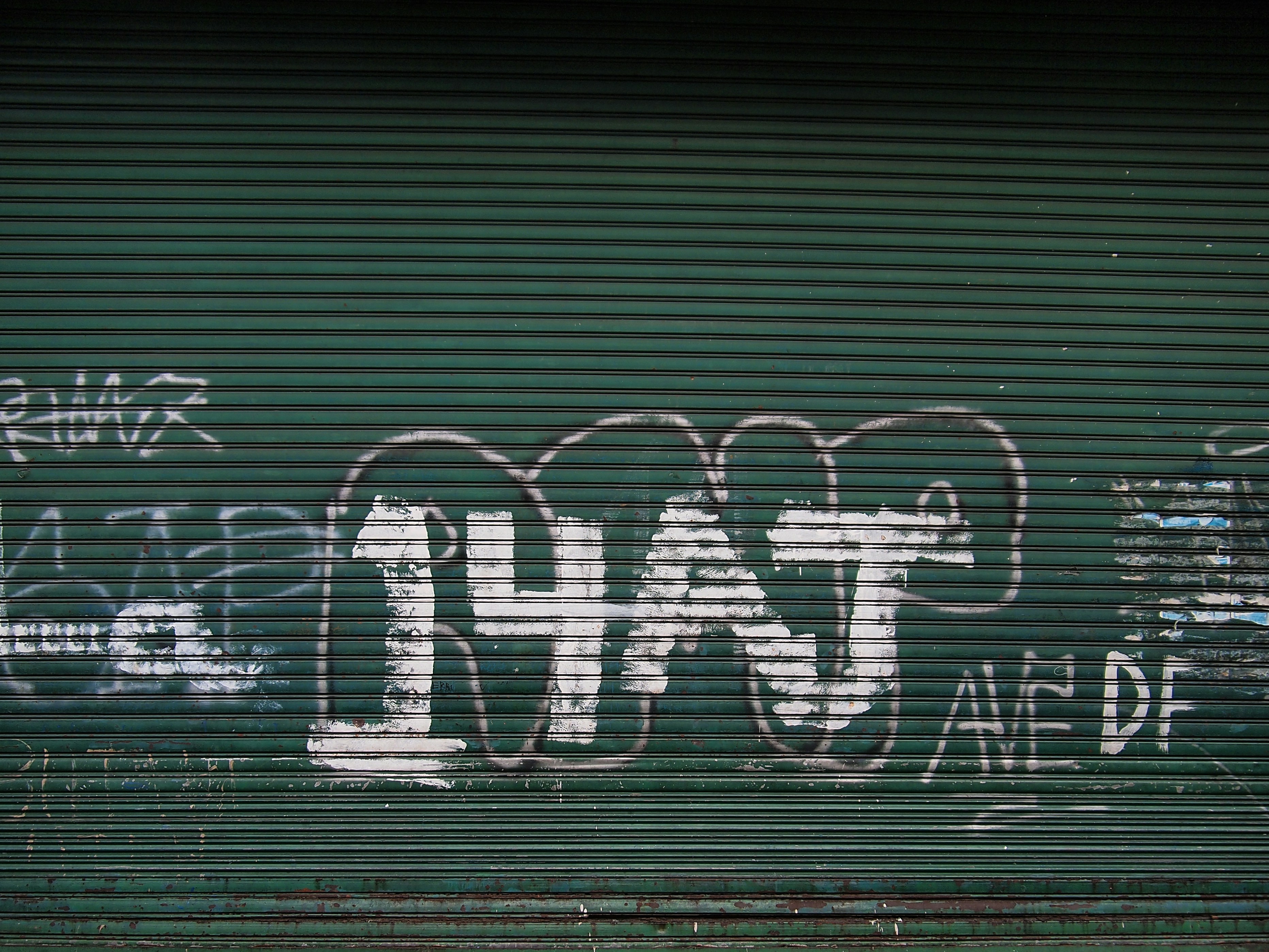a man sitting on a bench in front of a garage door