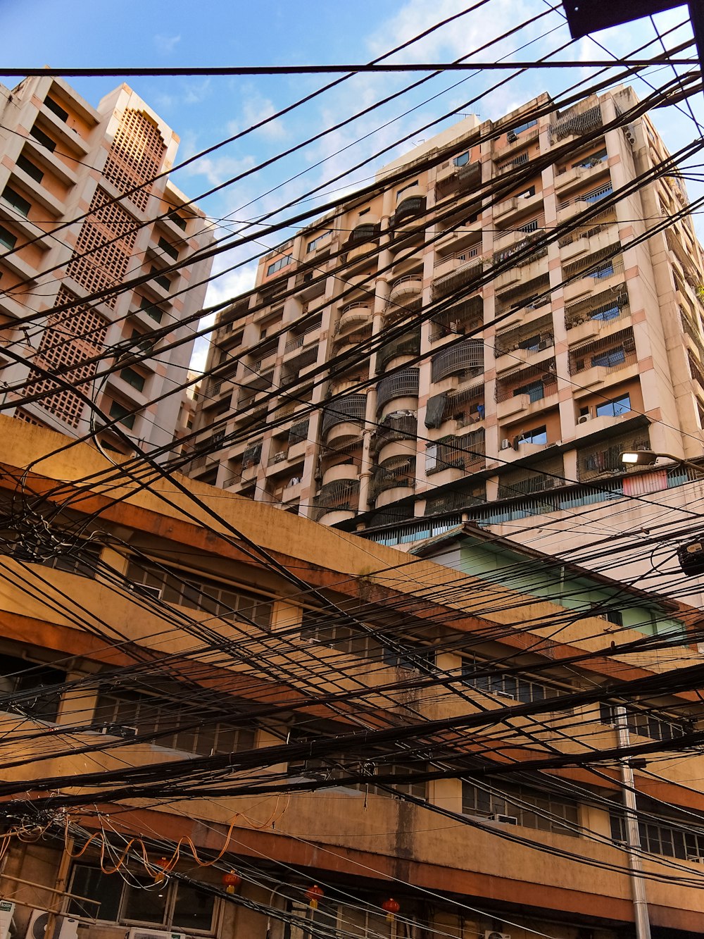 a tall building with lots of windows next to power lines