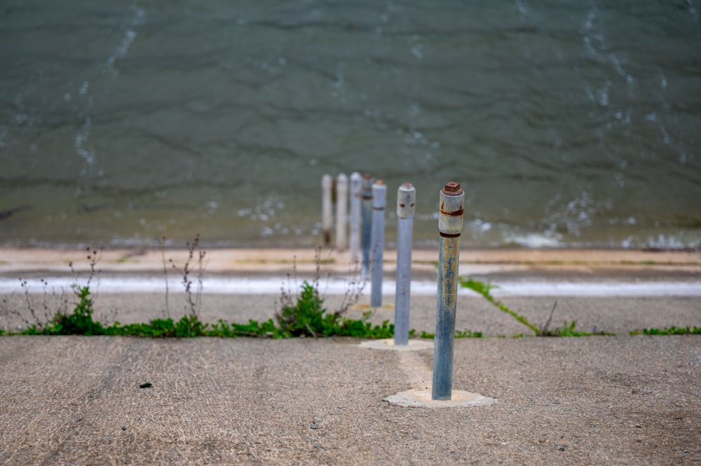 a couple of poles that are sitting in the sand