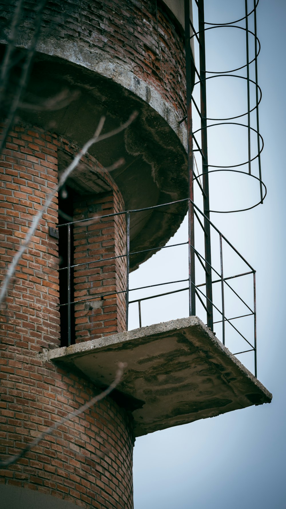 a tall brick tower with a clock on it's side