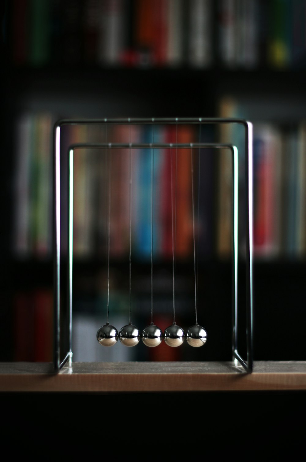 a metal newton scale with three balls on it