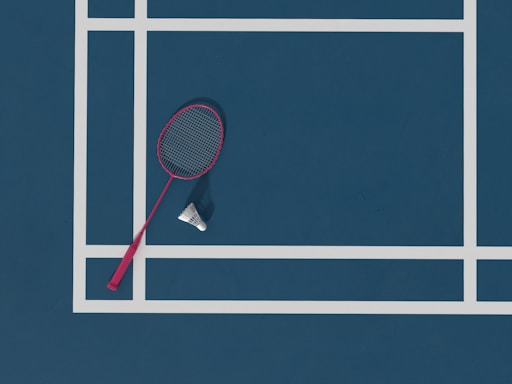 a tennis racket and ball on a tennis court