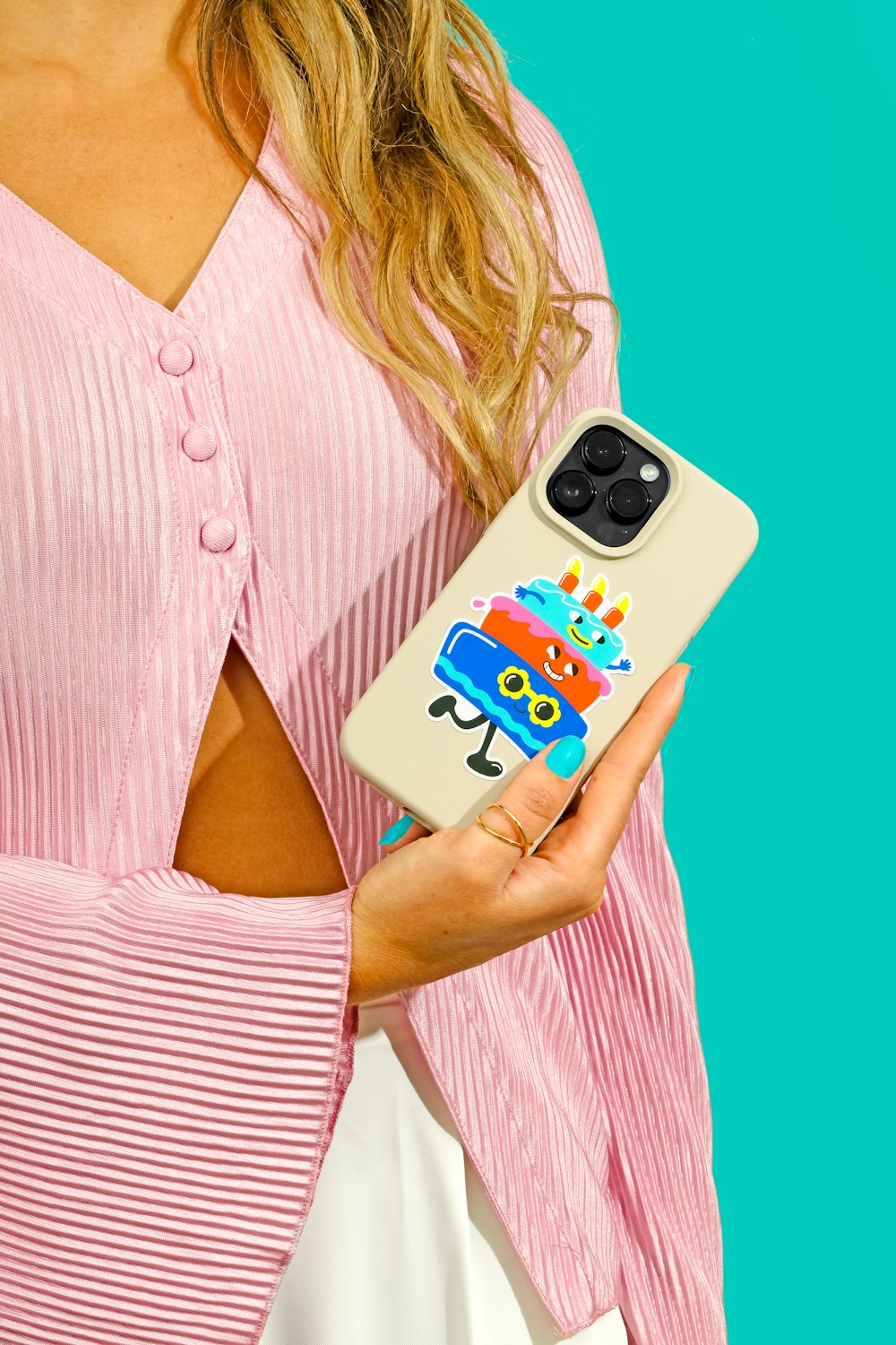 a woman holding a phone case with a cartoon character on it