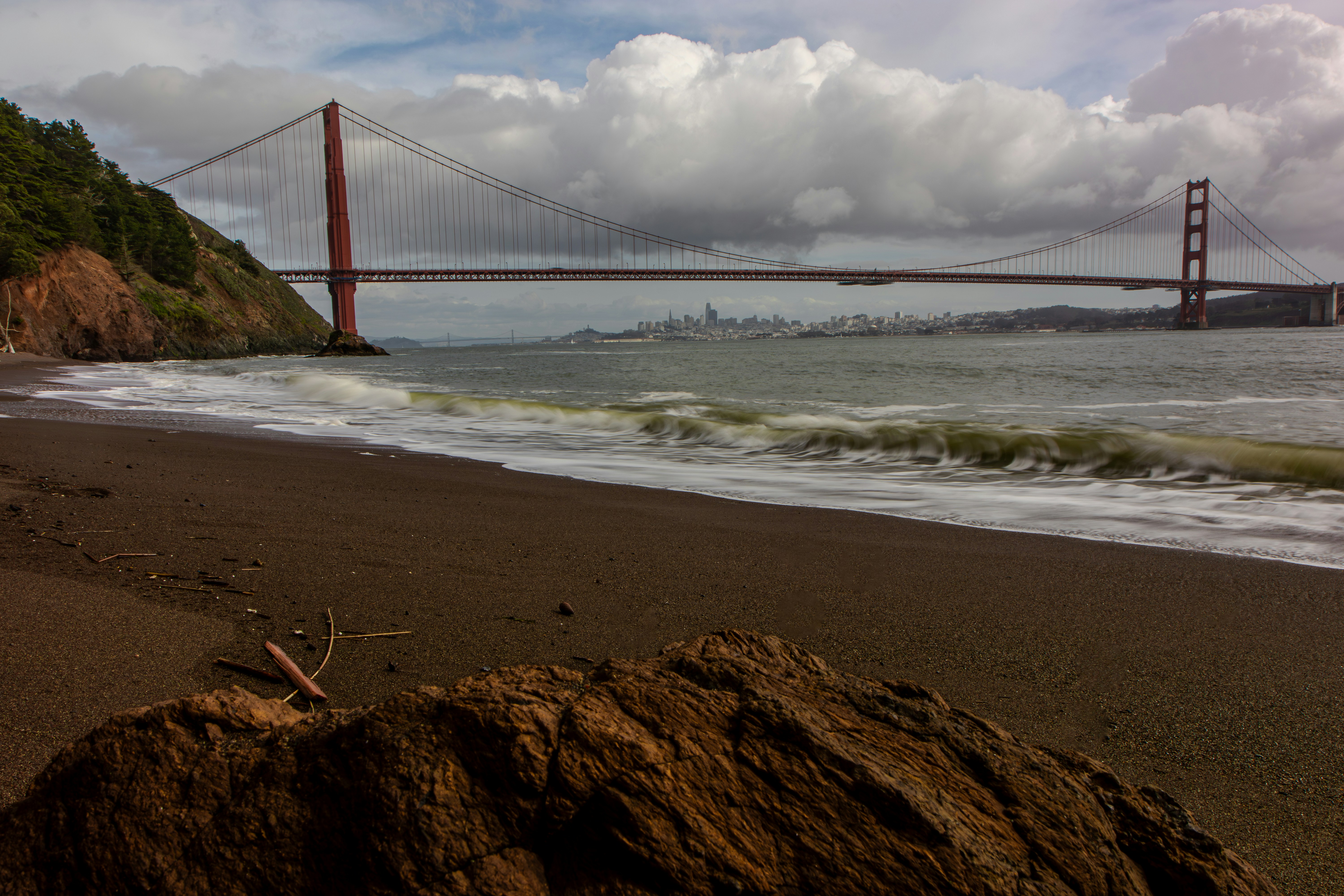 a view of the golden gate bridge from the beach
