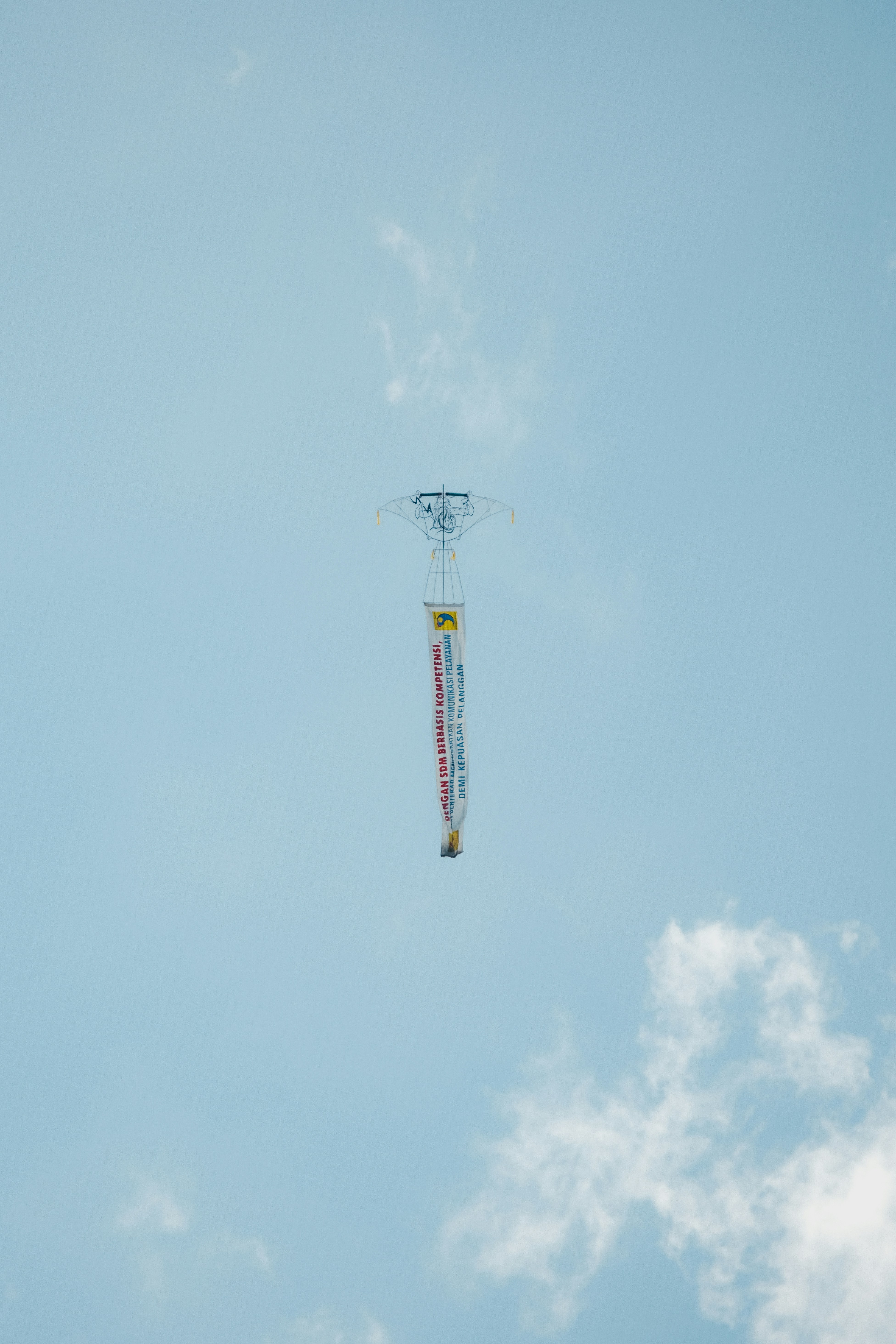 Low angle view of kite flying against clear blue sky