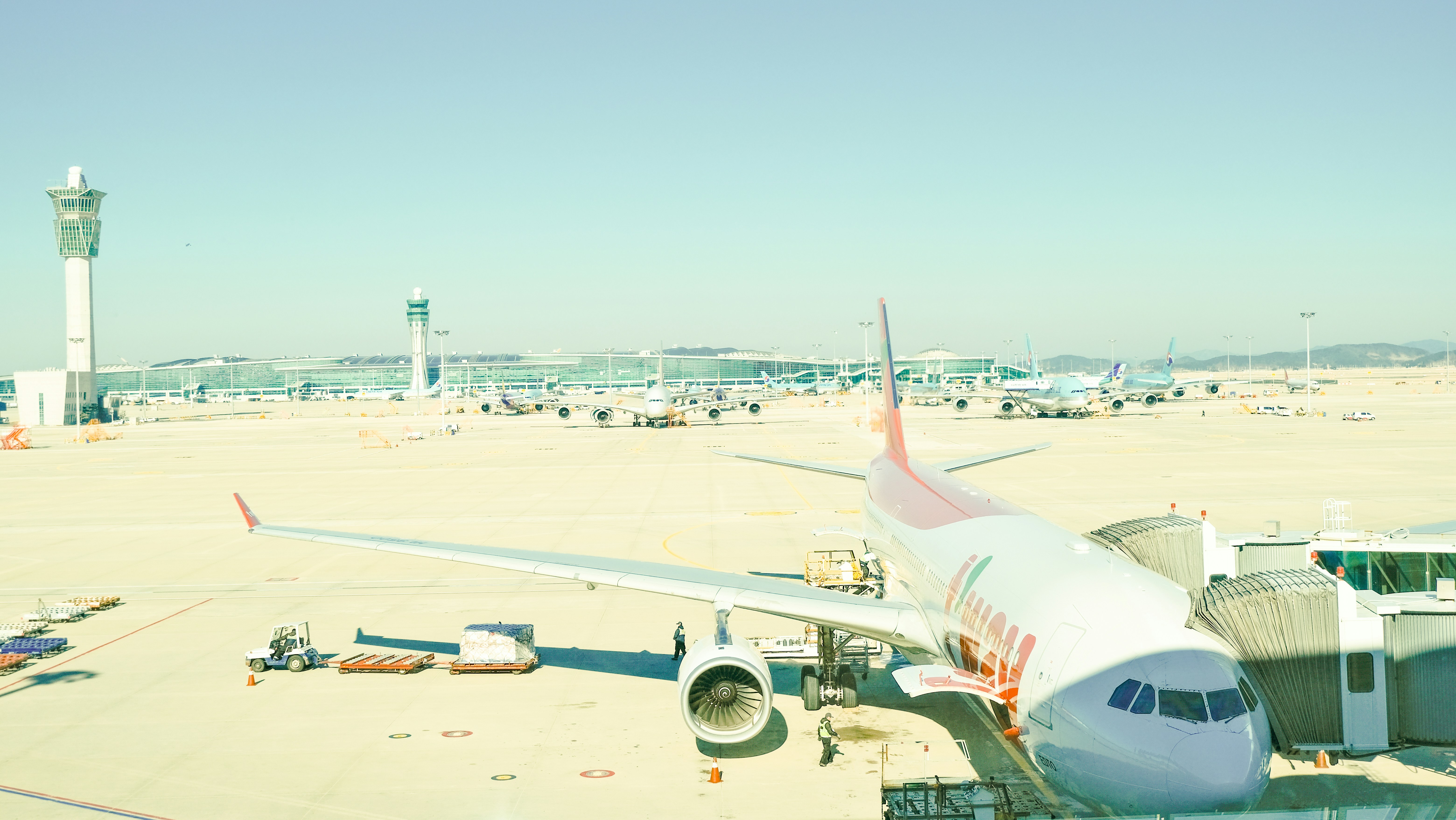 a large jetliner sitting on top of an airport tarmac, 