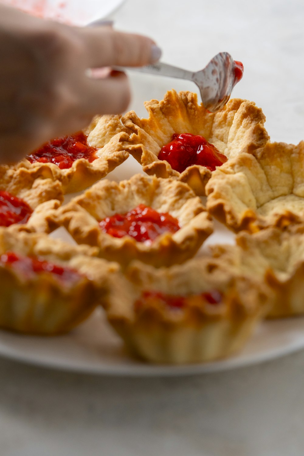 a person cutting into a pie on a plate