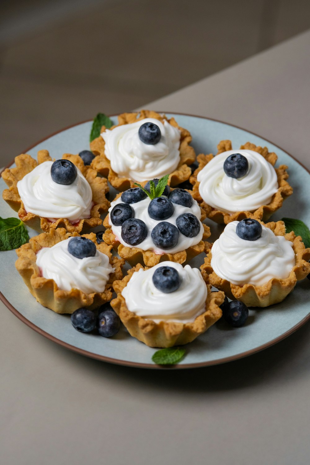 a white plate topped with blueberries and whipped cream