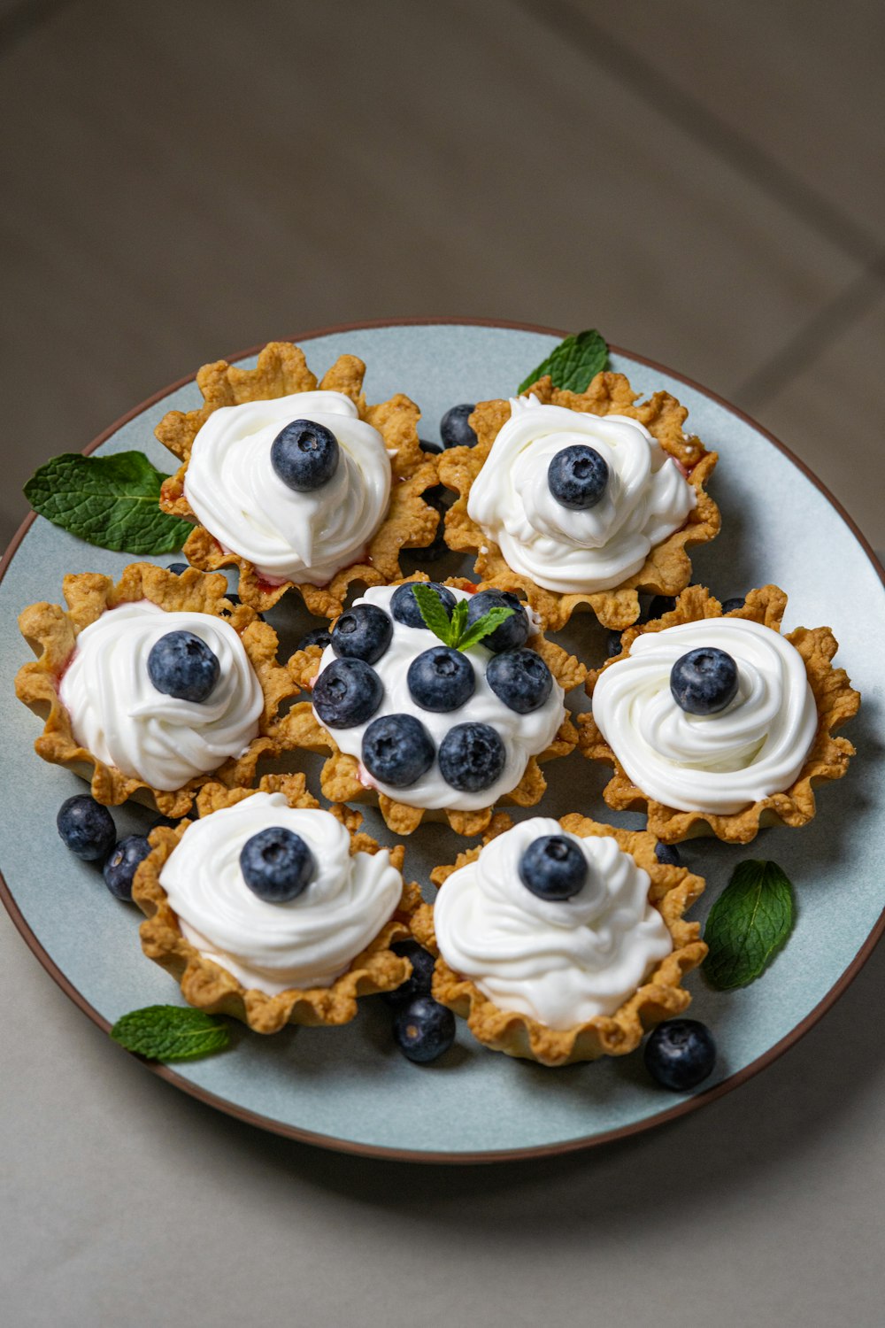 a white plate topped with blueberries and whipped cream