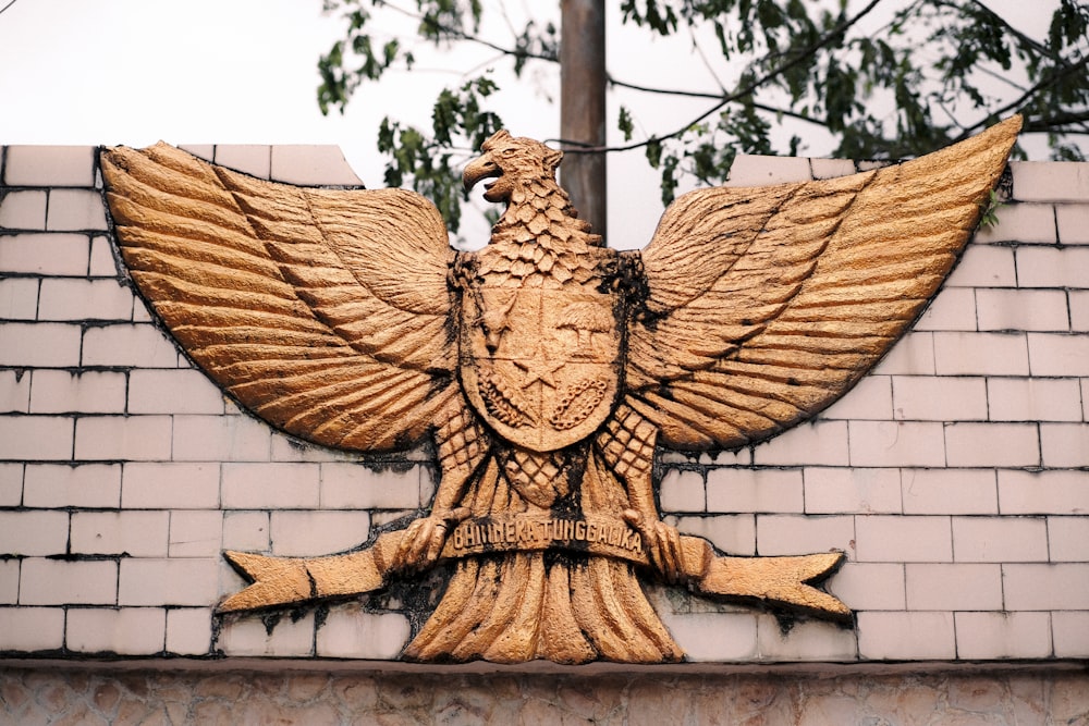 a decorative bird on the side of a building