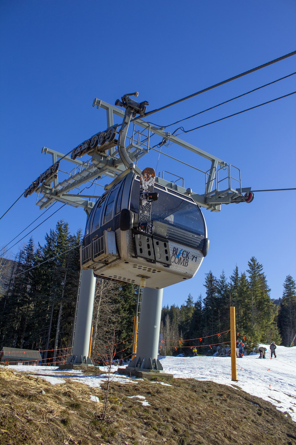 a ski lift going up a snowy hill