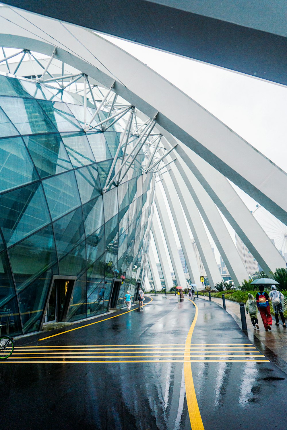 a large glass building with a yellow line on the side of it