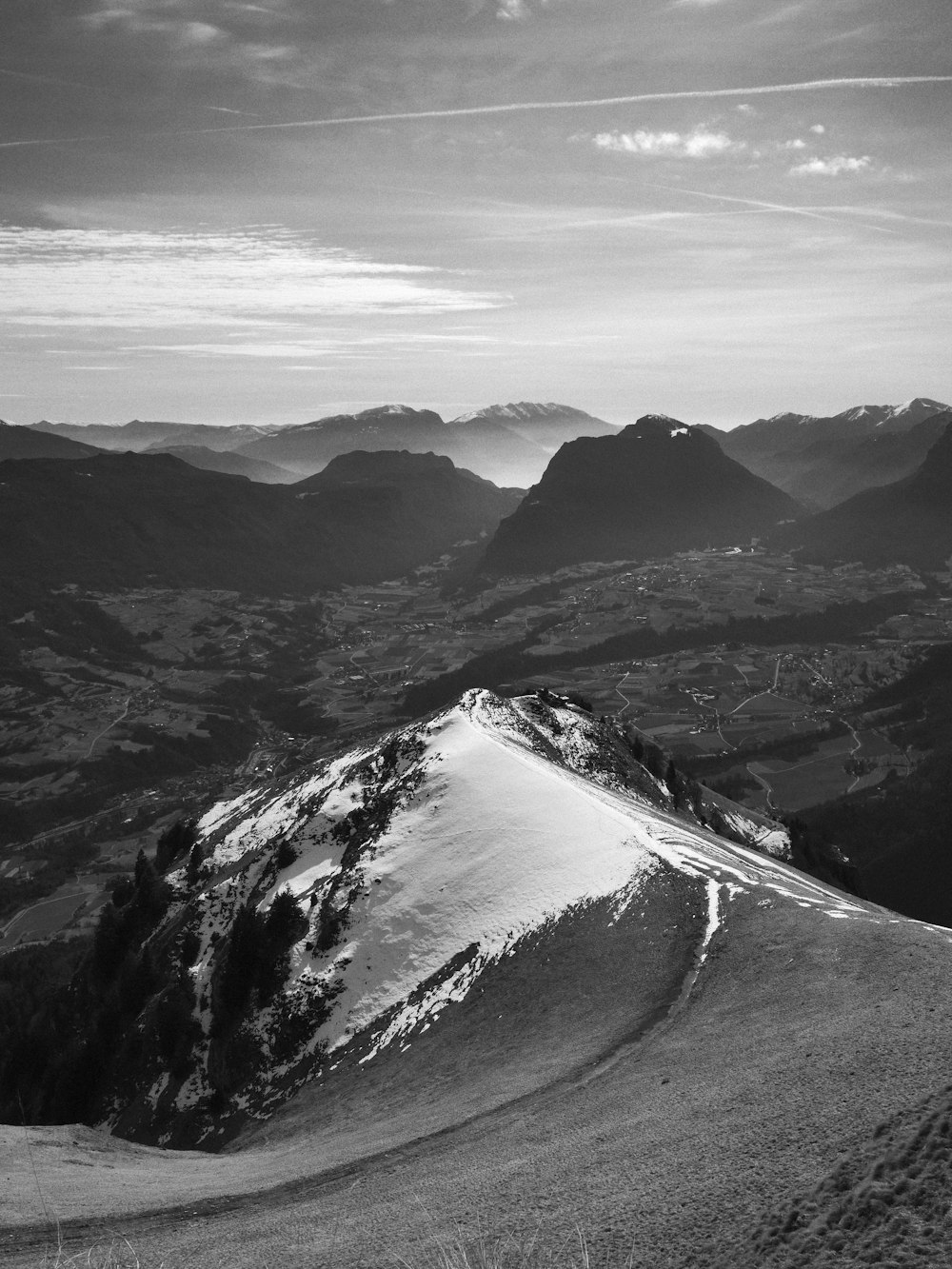 a black and white photo of a snow covered mountain