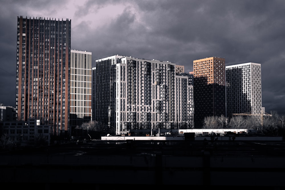 a group of tall buildings under a cloudy sky