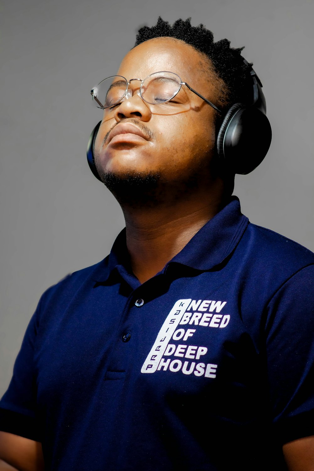 a man wearing headphones and a blue shirt