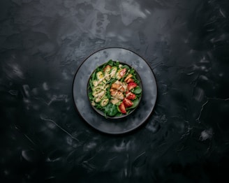 a white plate topped with a salad on top of a table
