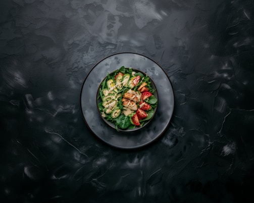 a white plate topped with a salad on top of a table