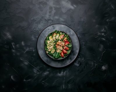 a white plate topped with a salad on top of a table