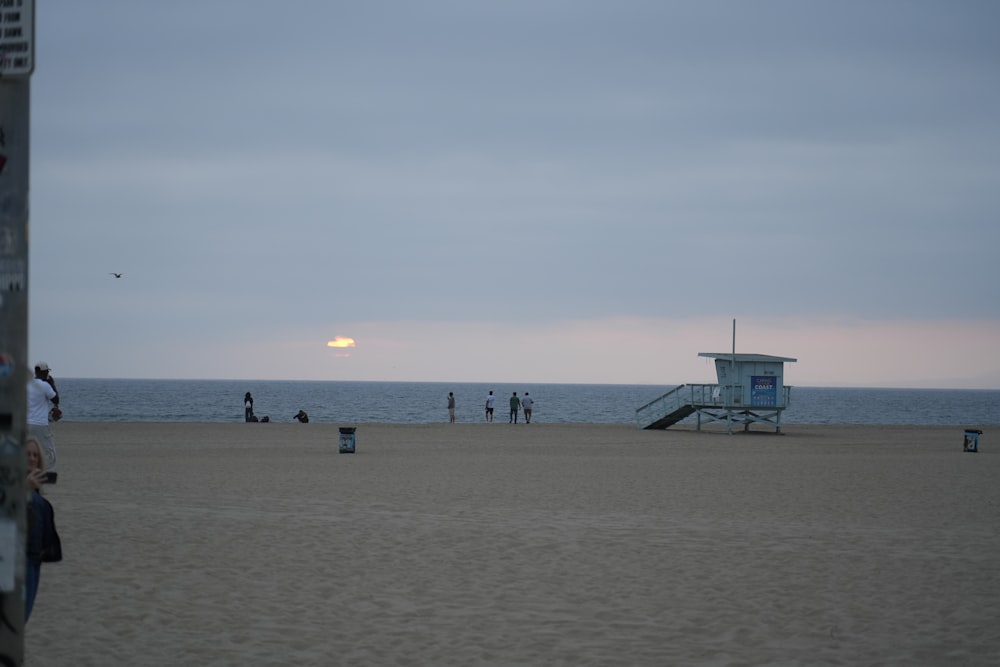 a lifeguard station on the beach with people on it