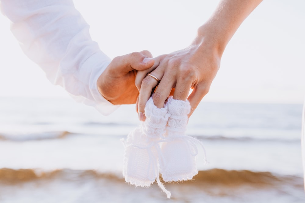 a close up of two people holding hands