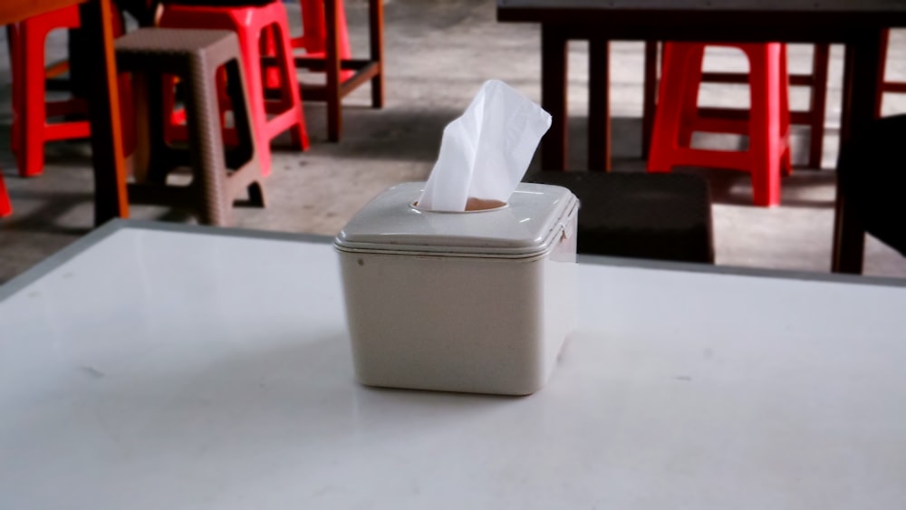 un dispensador de pañuelos de papel encima de una mesa