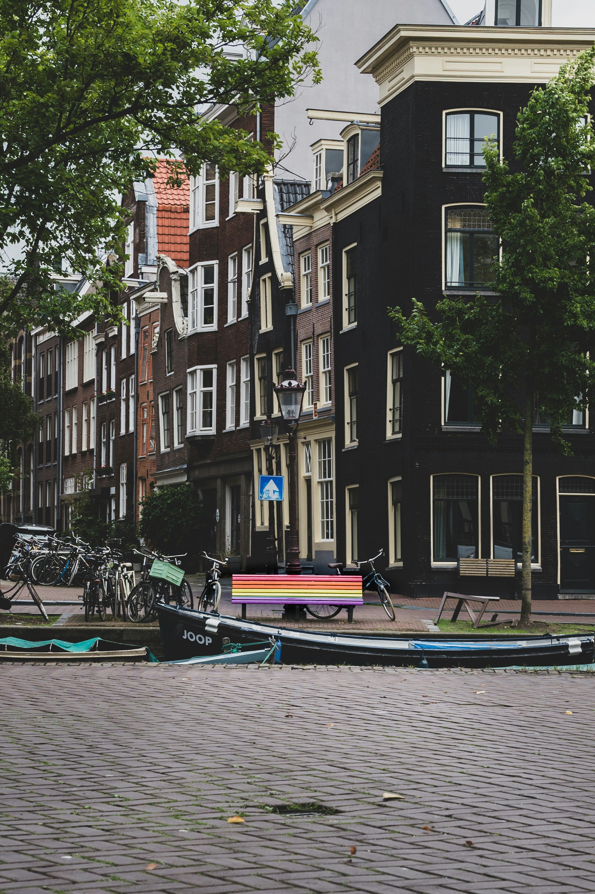 a row of boats sitting on the side of a road