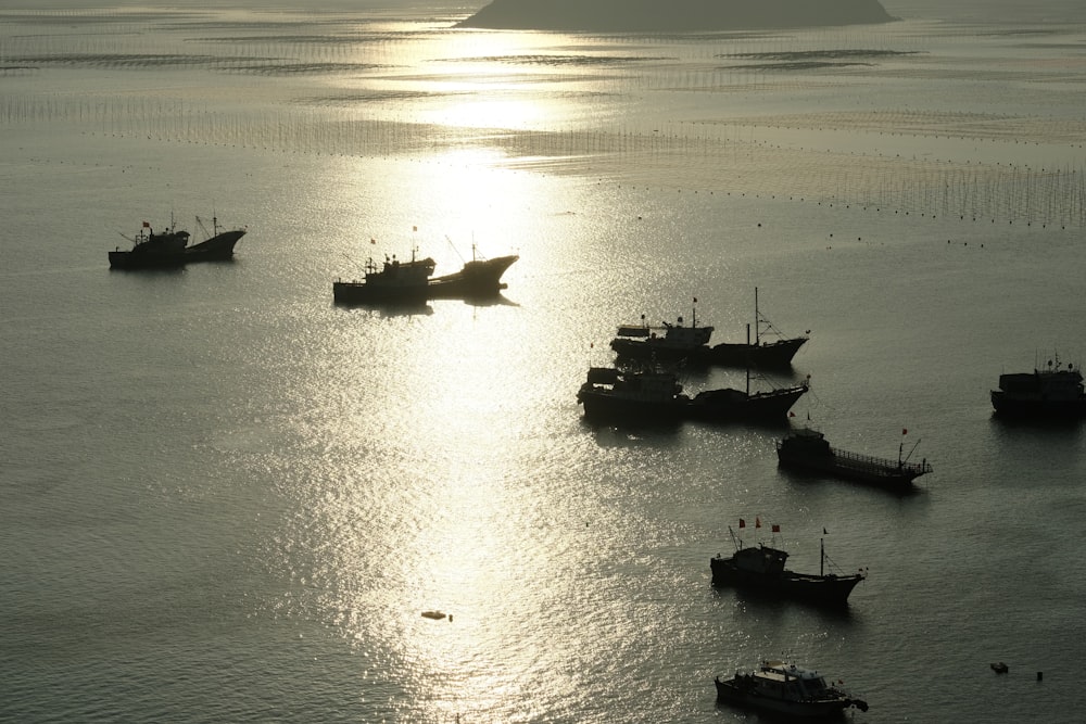 a group of boats floating on top of a large body of water