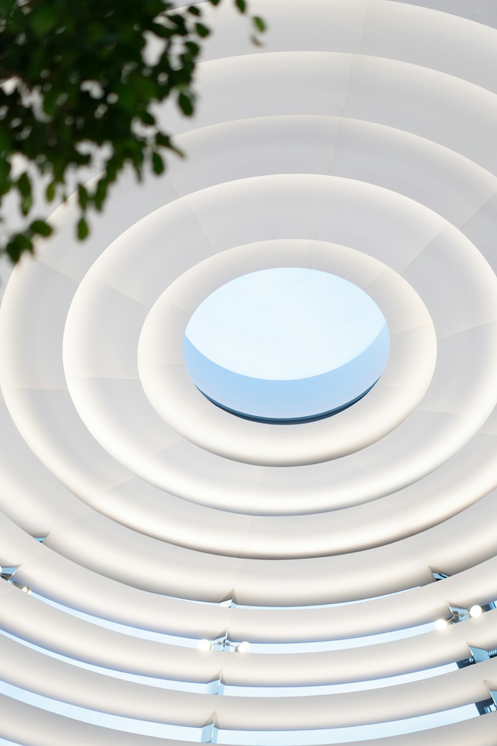 a white circular structure with a skylight in the center
