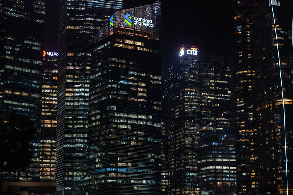 a large group of tall buildings lit up at night
