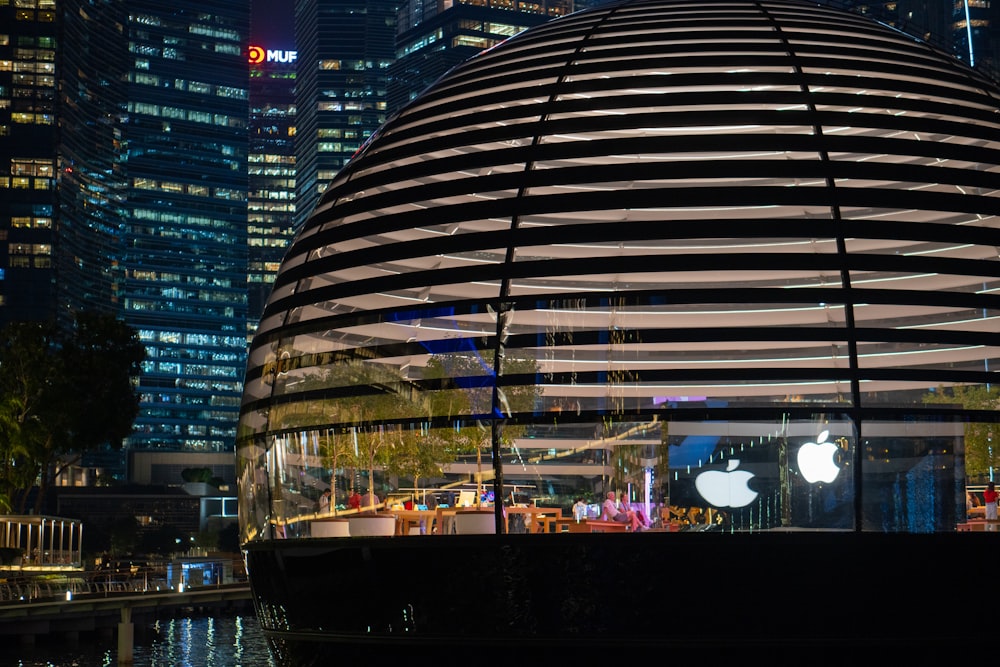 an apple store in the middle of a city at night