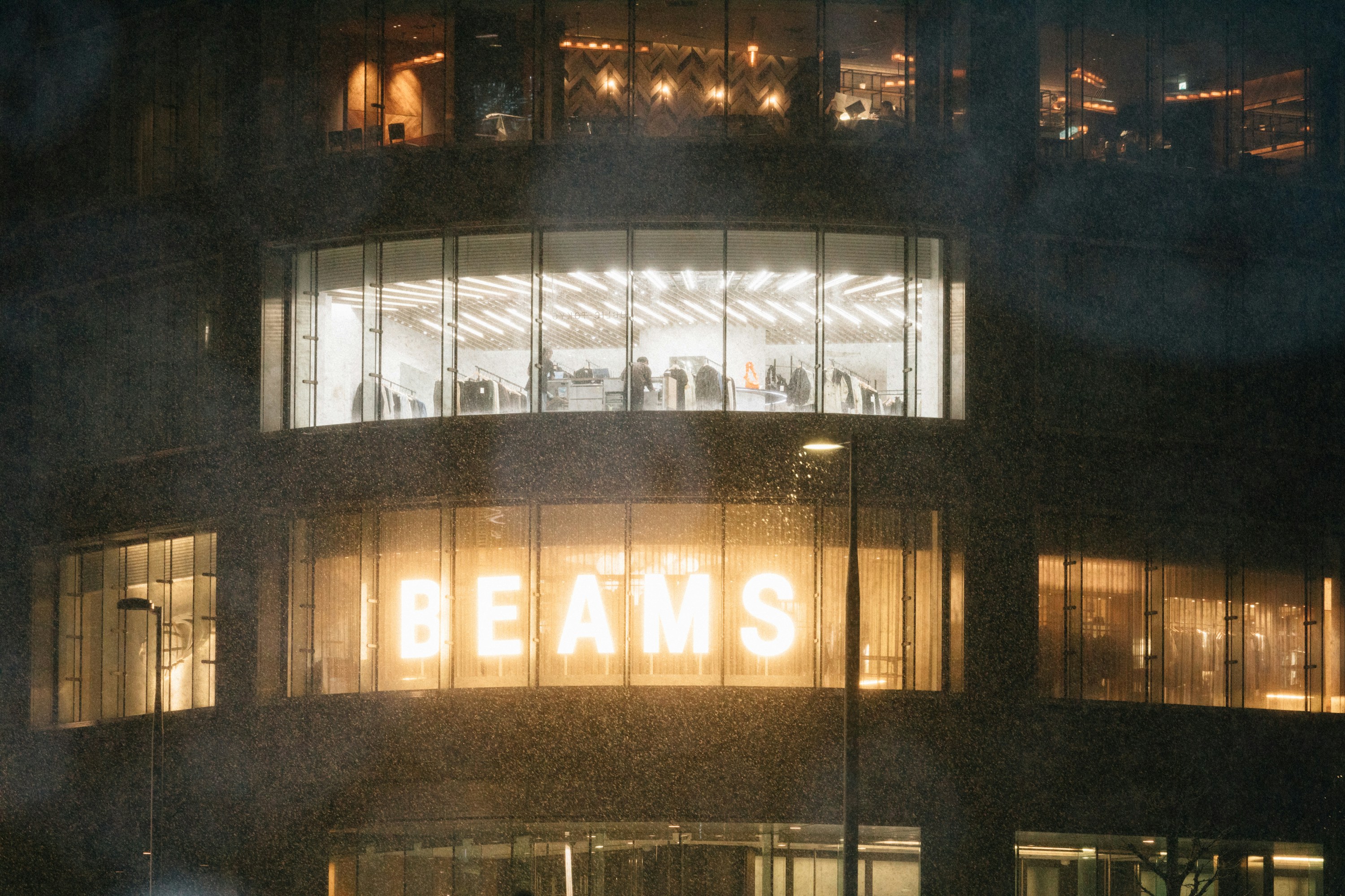 a view of a building at night with the word beams lit up
