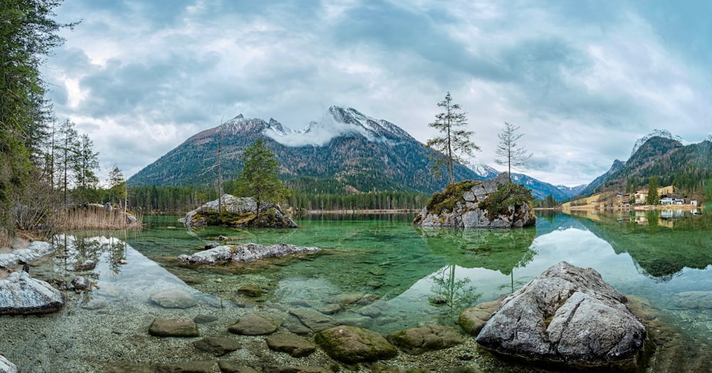 a body of water surrounded by mountains and trees