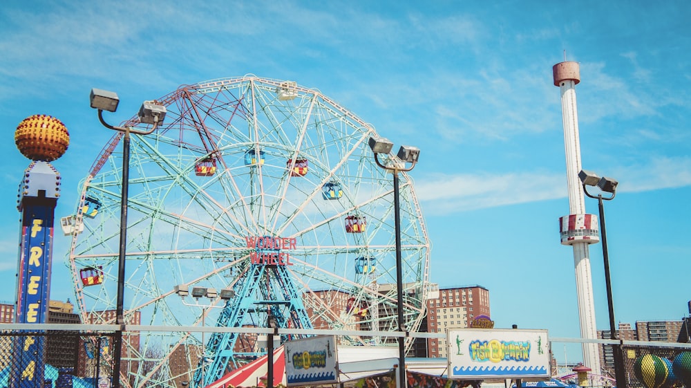 an amusement park with a ferris wheel in the background