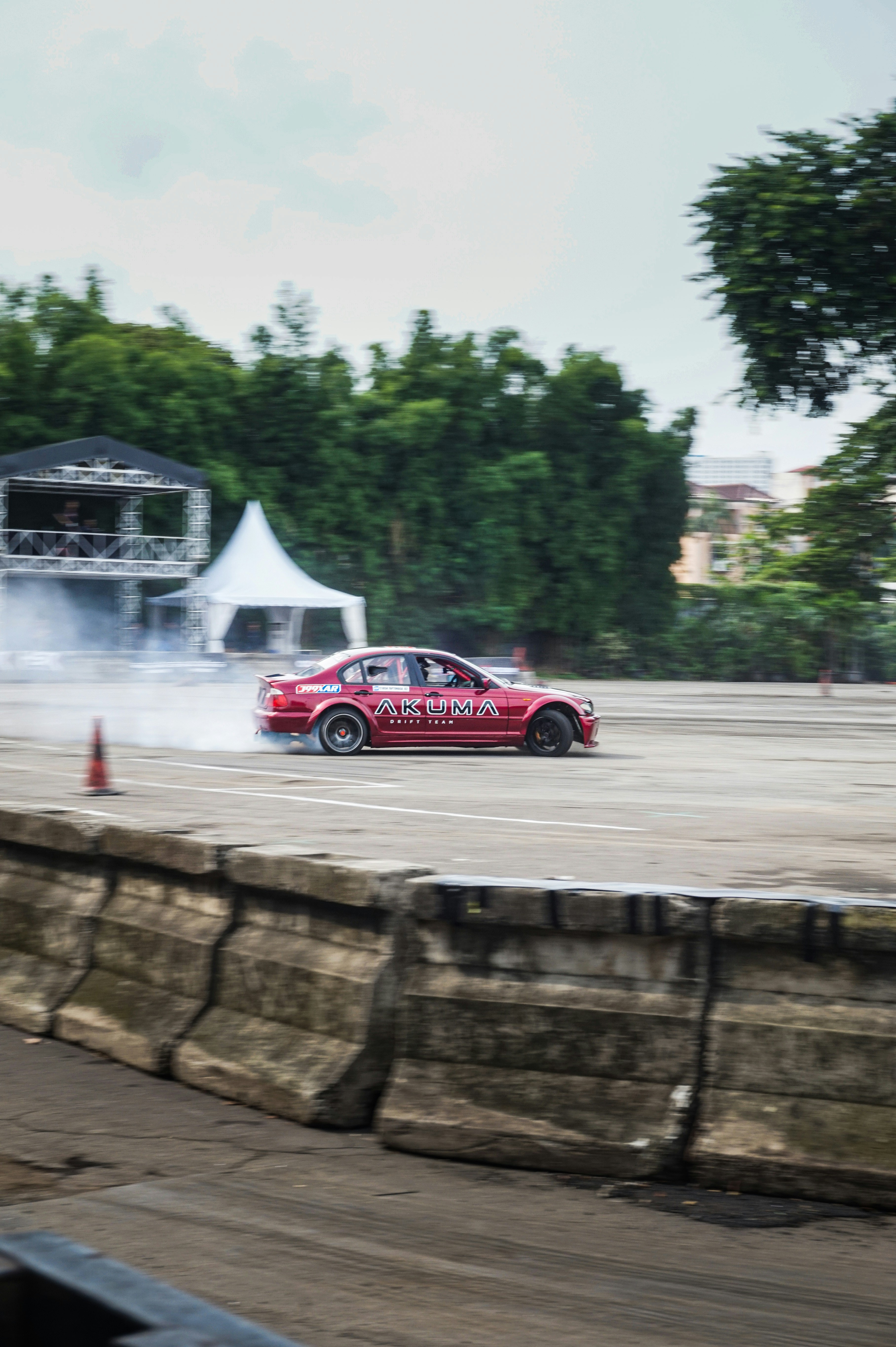 a red car driving down a race track