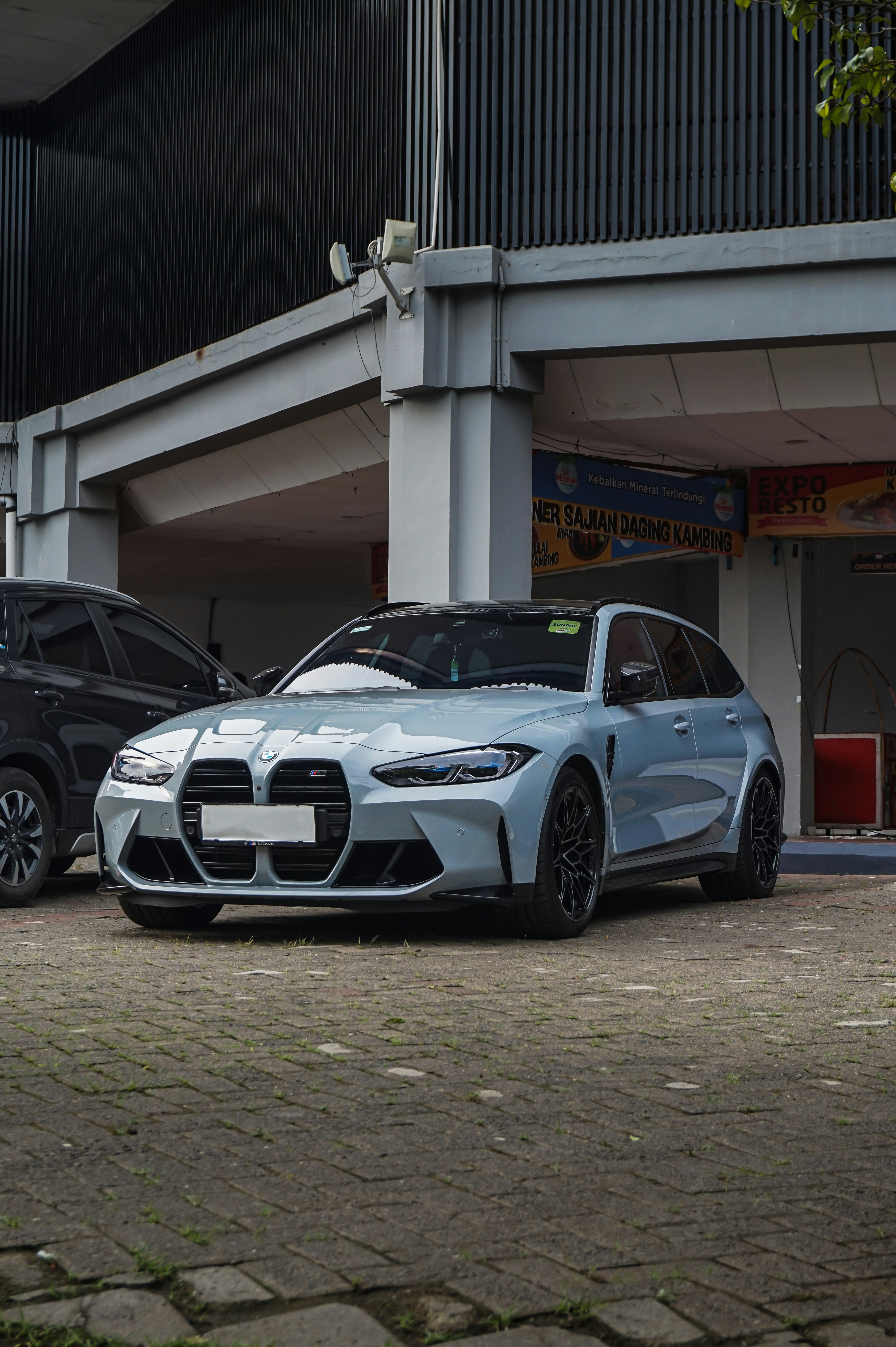 two cars parked in front of a building