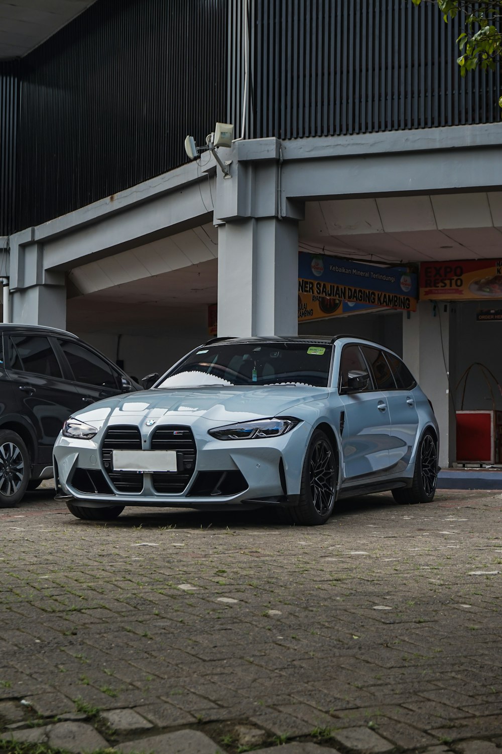 two cars parked in front of a building