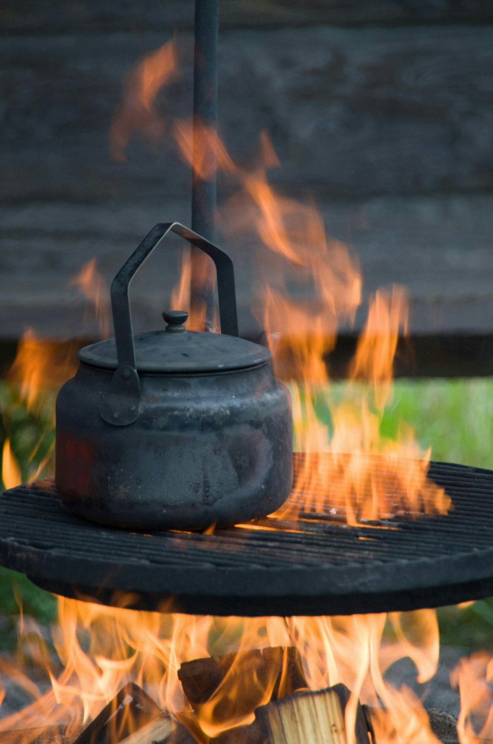 a kettle sitting on top of a fire pit